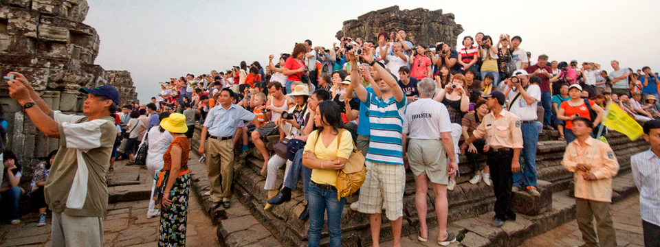 Recommendations - Uncontrolled tourism allows hordes of tourists to climb the ruins at Angkor, Cambodia. Photo: Paul Stevenson