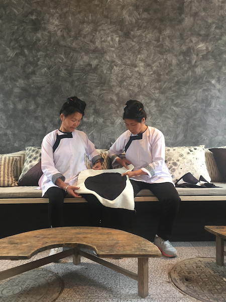 THE DYE ROOM, BEIJING, CHINA  Two women from Dali Village pose with one of their creations, which were exhibited in The Dye Room for Beijing Design Week 2016. ©Studio ATLAS/Global Heritage Fund